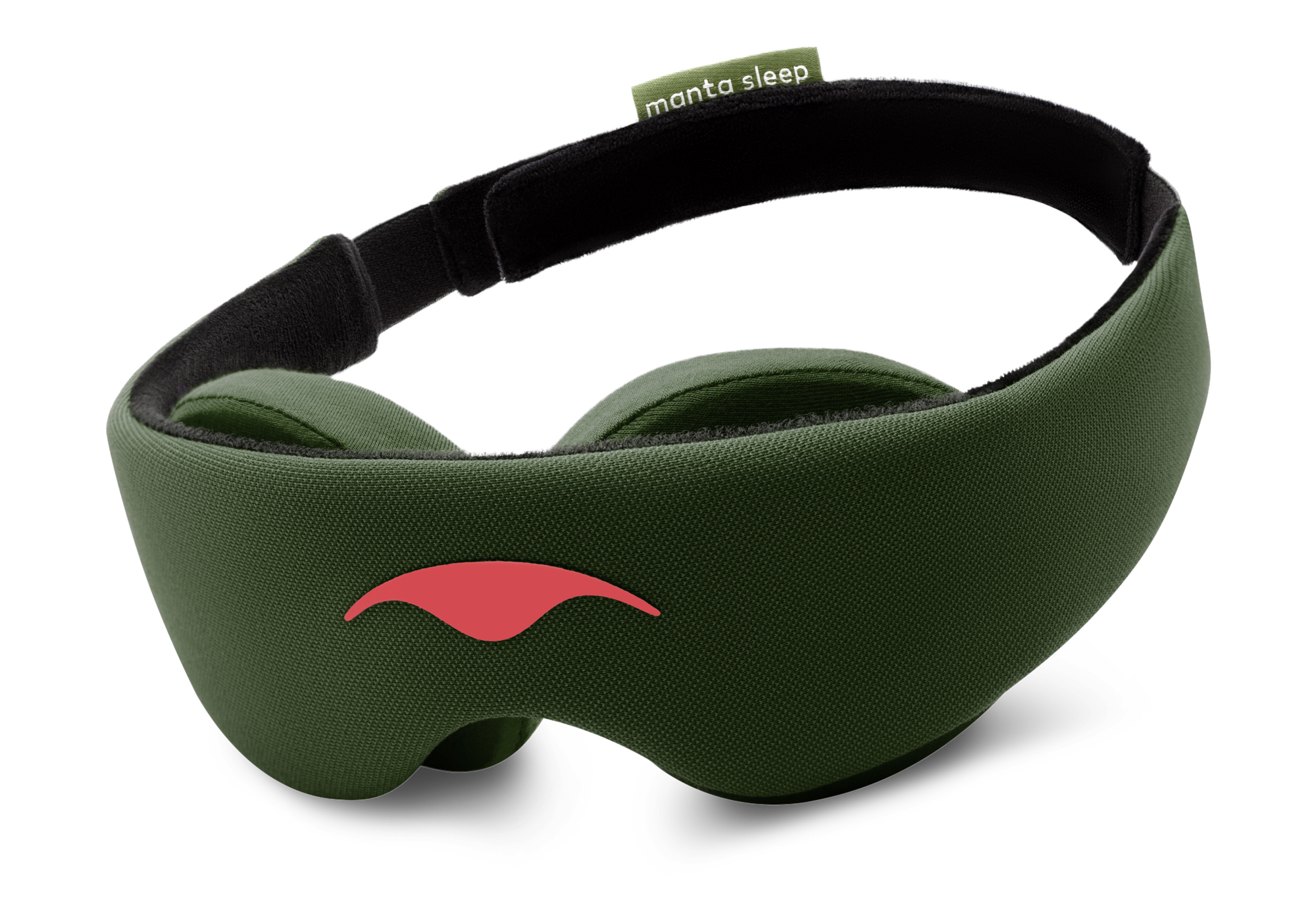 An angled product shot of the forest green Manta Sleep Mask floating against a pure white background. The mask features a smooth, deep green fabric exterior with a contrasting coral-red logo on the front forehead portion, thick black contoured lining, and a small green brand tag on the rear strap.