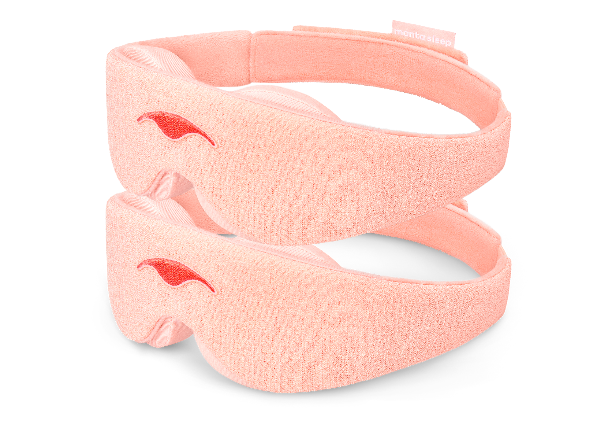 Two Sunrise Pink Manta Sleep Masks are stacked vertically, isolated on a pure white background. Each mask displays its textured light pink exterior fabric, a centered darker pink embroidered Manta Sleep logo, and a glimpse of the plush, contoured interior eye padding.