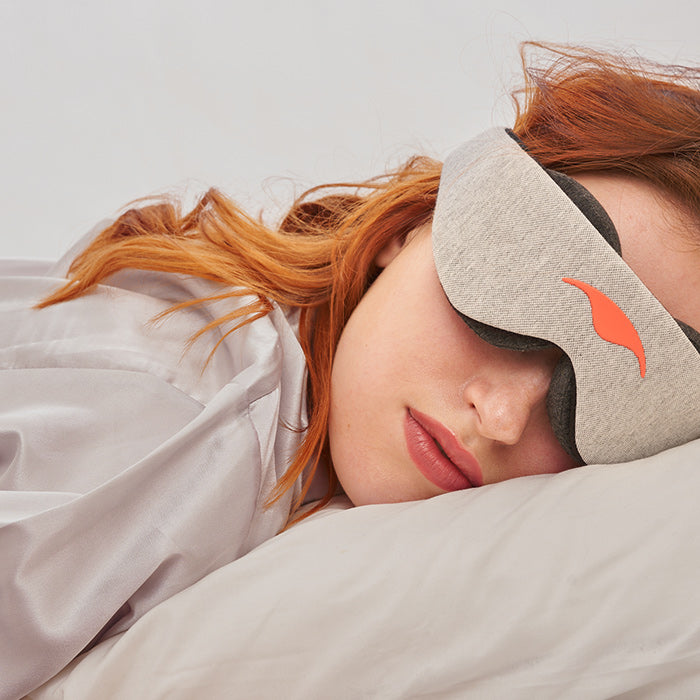 a woman sleeping with a mask on her face