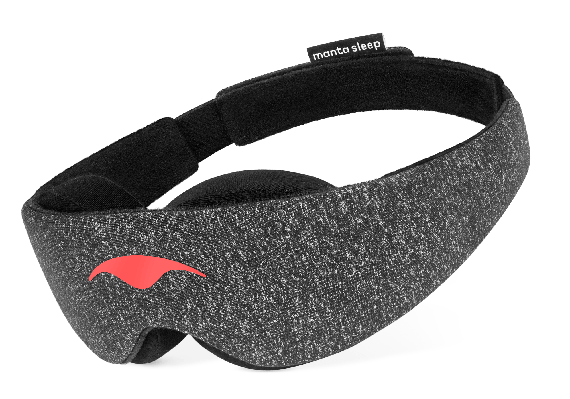 An angled product shot of the Carbon Black Manta Sleep Mask floating against a pure white background. The mask is constructed from dark gray speckled heather fabric with a smooth coral-red logo on the front, thick black contoured eye padding underneath, and a black brand tag on the rear strap.