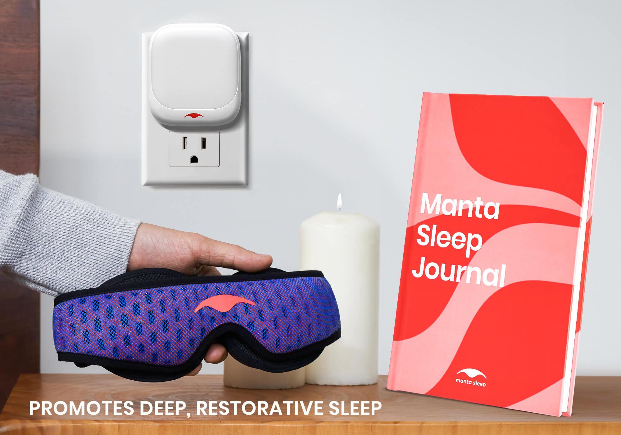 A hand holding a red and blue Manta PRO Sleep mask next to a standing Manta Sleep Journal, with candles and Manta TrueRed Night Light in the background, captioned: "Promotes deep, restorative sleep".