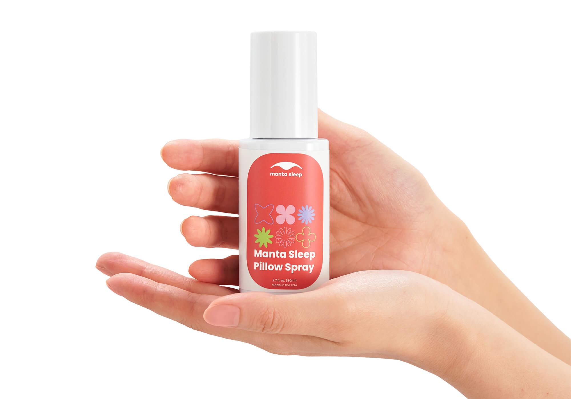 Two hands gently cupping and holding a white bottle of Manta Sleep Pillow Spray, isolated on a white background.