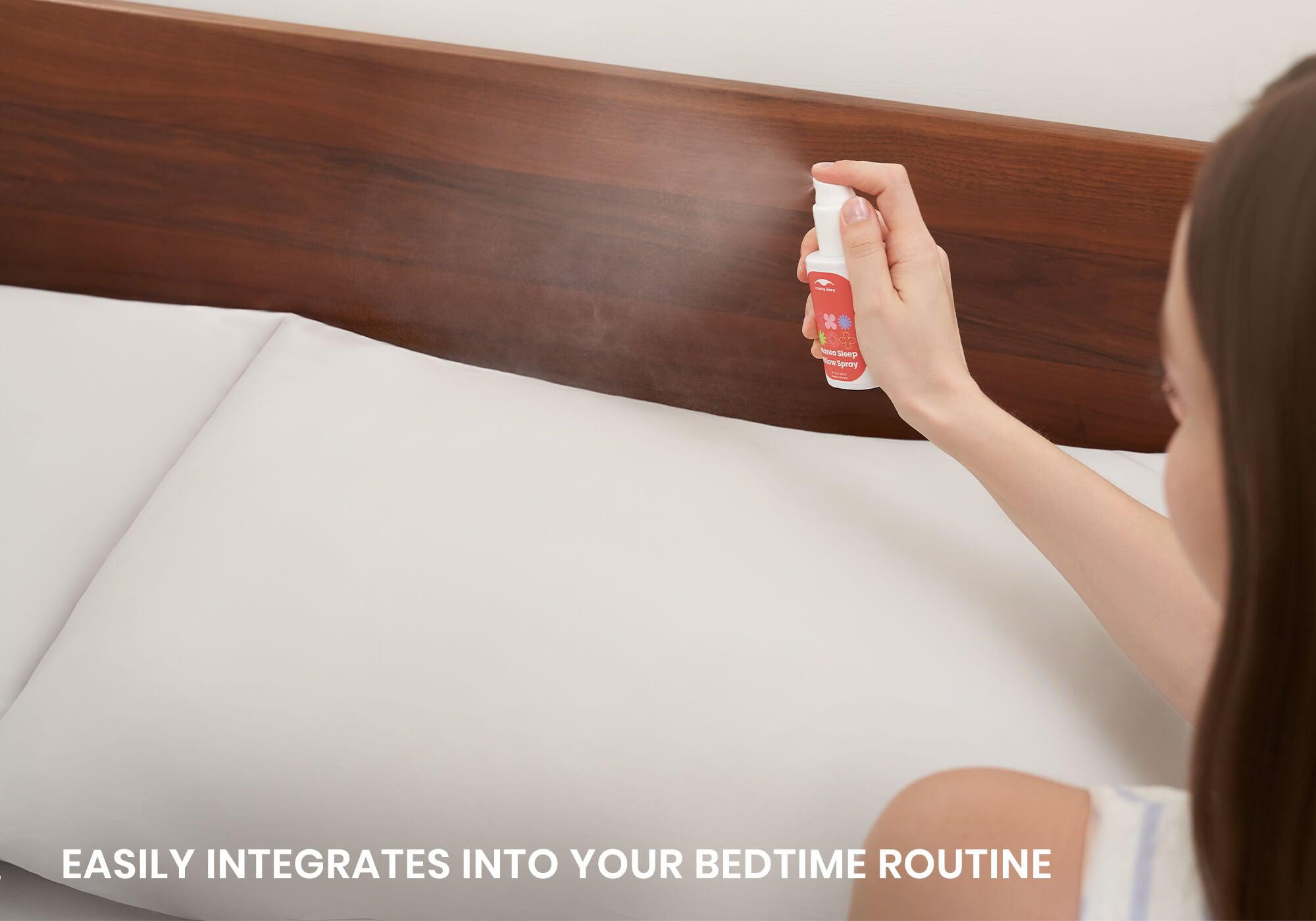 Close-up of a hand spraying Manta Sleep Pillow Spray over a white bed pillow. Text reads: Easily integrates into your bedtime routine.