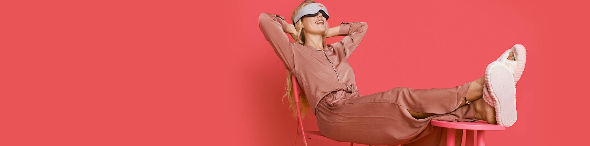 a woman sitting in a chair with her hands behind her head