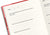 Top-angle close-up view of an open notebook page with structured prompt questions and date entry fields.