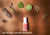 Top-down view of Manta Sleep Pillow Spray surrounded by organic ingredients like lavender, citrus, and bark. Text: 100% natural, organic ingredients.