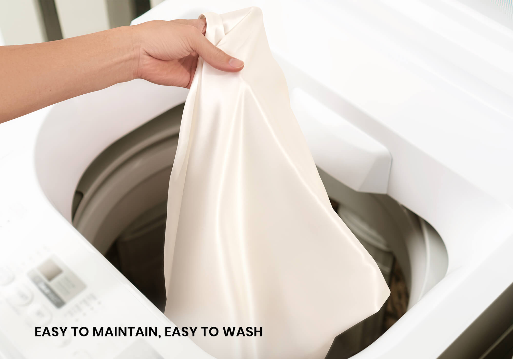 A hand lifting a pearl white silk pillowcase out of a white washing machine. Text overlay: "Easy to maintain, easy to wash".