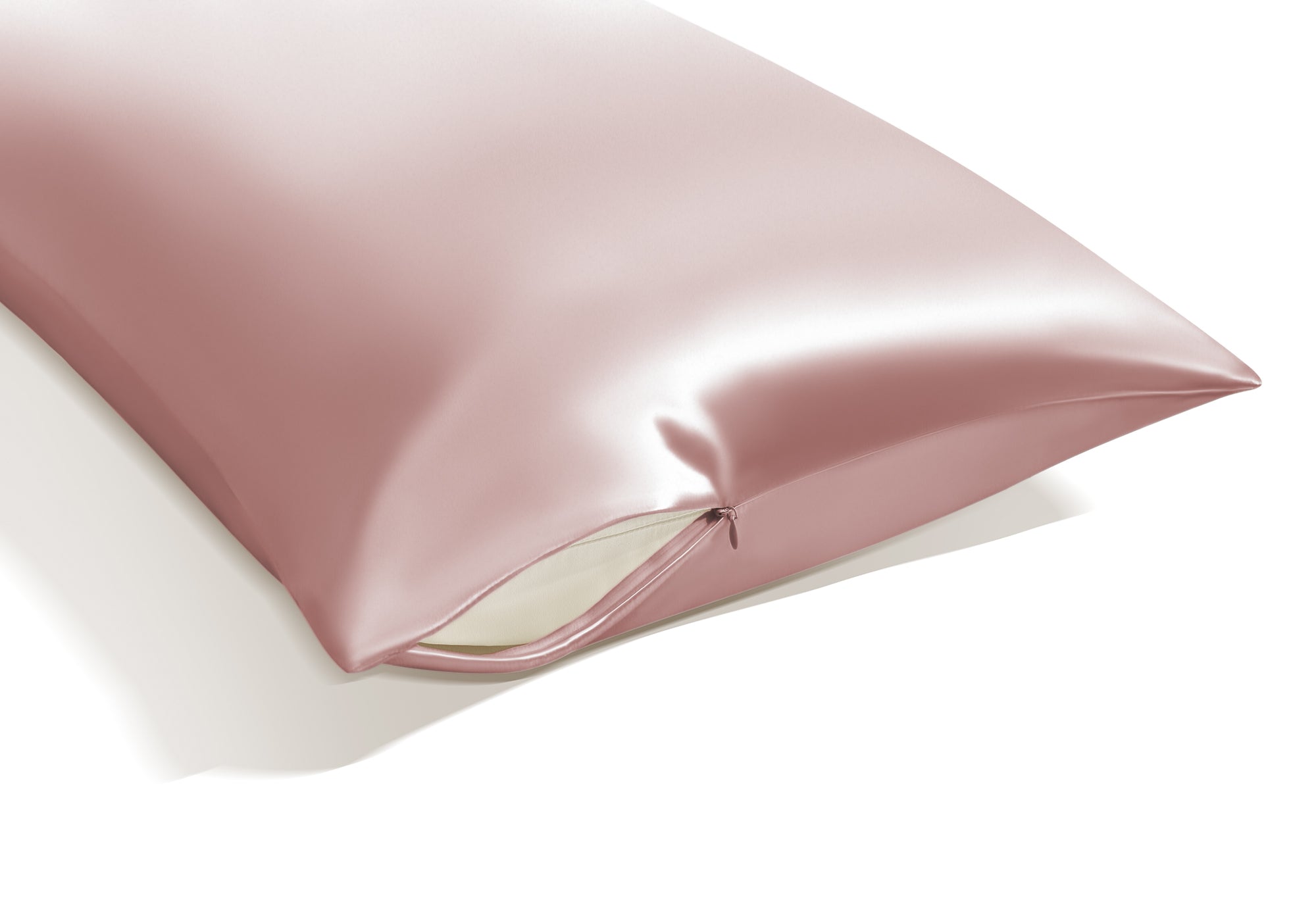Close-up view of the corner of a rose pink Manta Sleep silk pillowcase showcasing its premium hidden zipper closure.