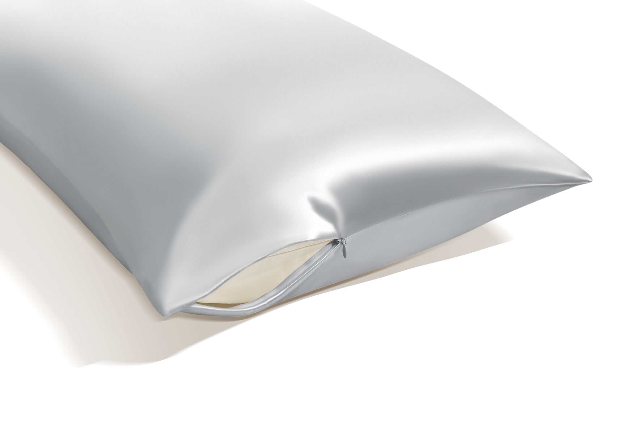 Close-up view of the corner of a crystal silver Manta Sleep silk pillowcase showcasing its premium hidden zipper closure.