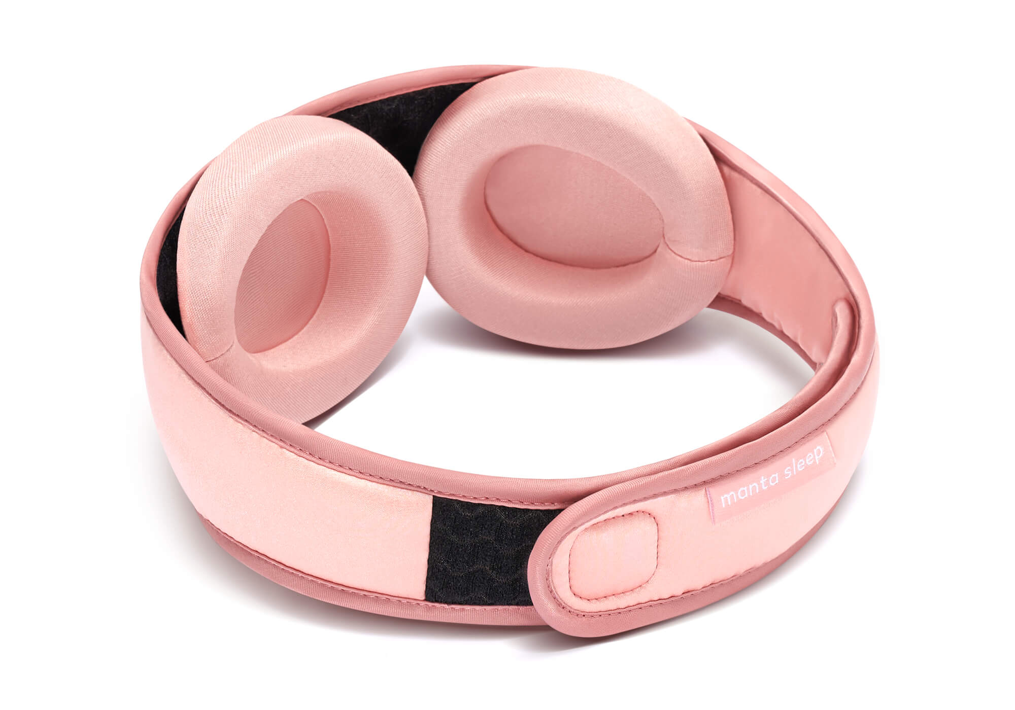 Interior view of a pink Manta SILK Sleep Mask, showing the two detachable padded eye cups and the black hook-and-loop strip on the inner band.