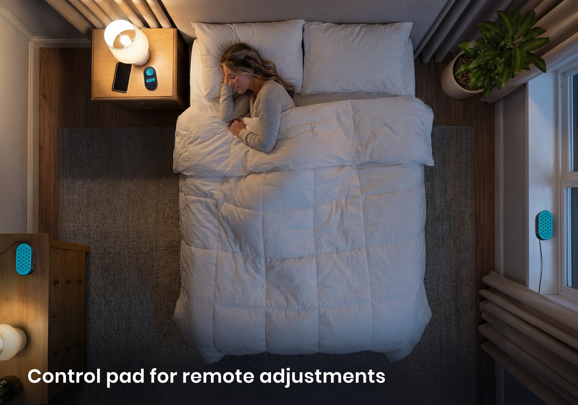 High-angle view of a woman sleeping in bed, with a white noise speakers, one on the window sill and one on the drawer, and their control pad on the nightstand.