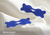 Two blue Manta nasal strips featuring the white Manta Sleep logo, displayed on textured white fabric. Text overlay: "Gentle on skin".