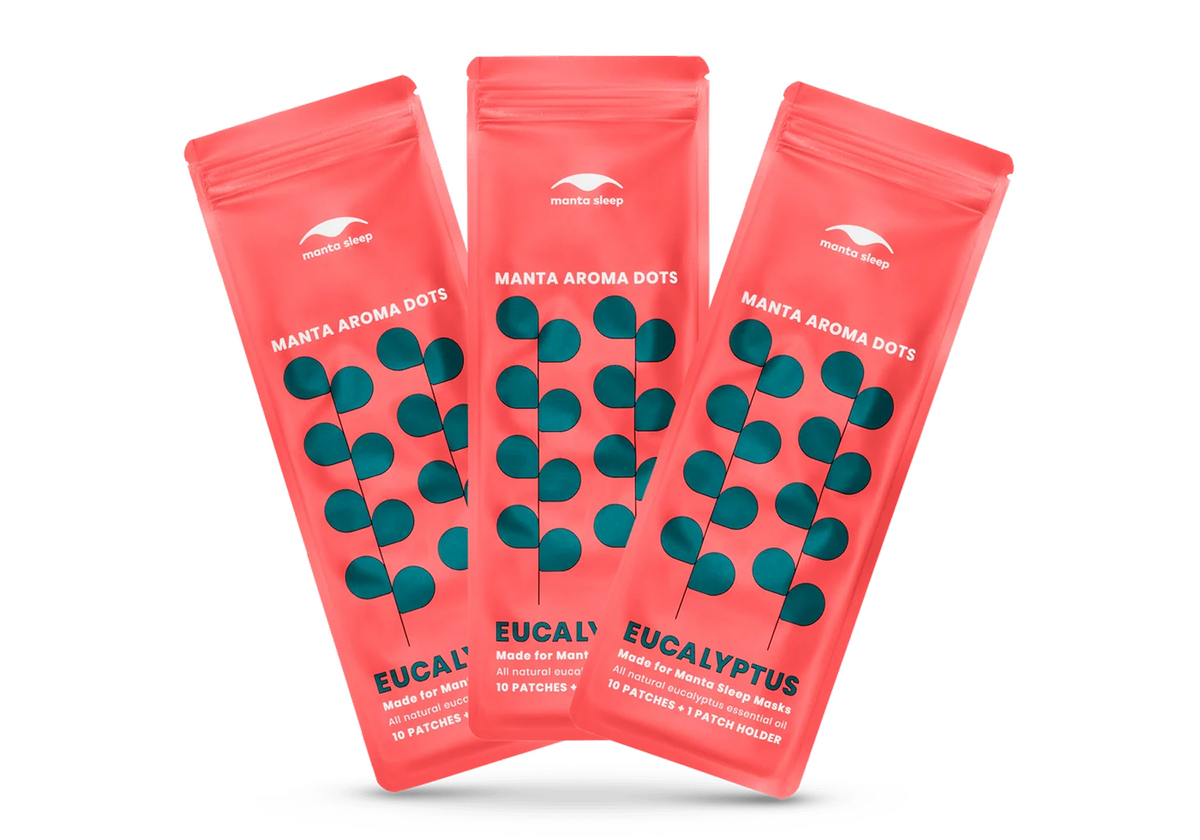 Three coral-red Manta Aroma Dots packets for the Eucalyptus variant arranged in a fan shape, isolated on a clean white background.