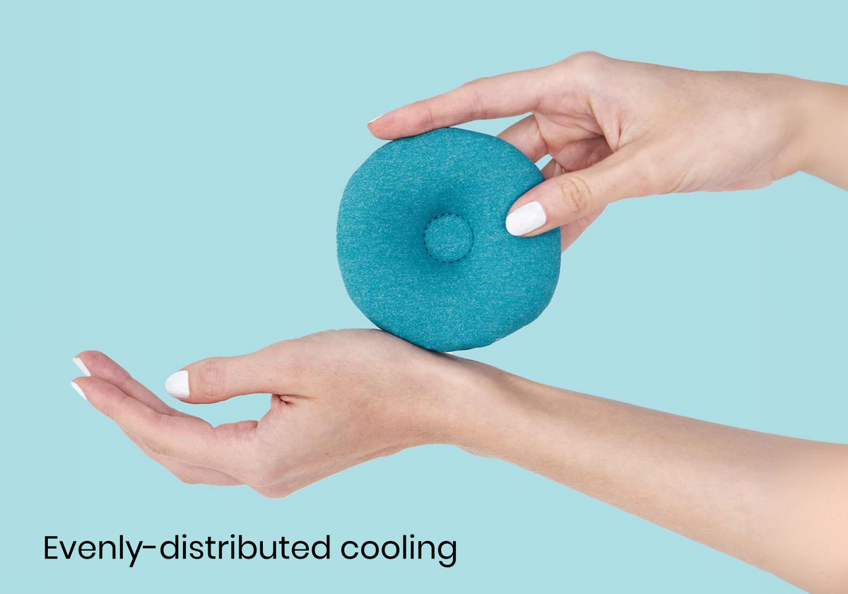 A teal blue Manta COOL Eye Cup held between two hands against a light blue background, with the text 'Evenly-distributed cooling'.