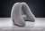A gray inflatable travel neck pillow shown in its inflated U-shape on a reflective surface with a dark gradient background. White text at the bottom reads 'Expands into a plush pillow in two quick breaths'.