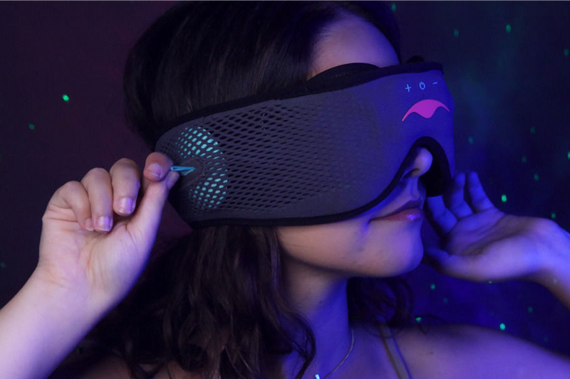 Person wearing a classic Manta SOUND Sleep Mask in a dark setting.