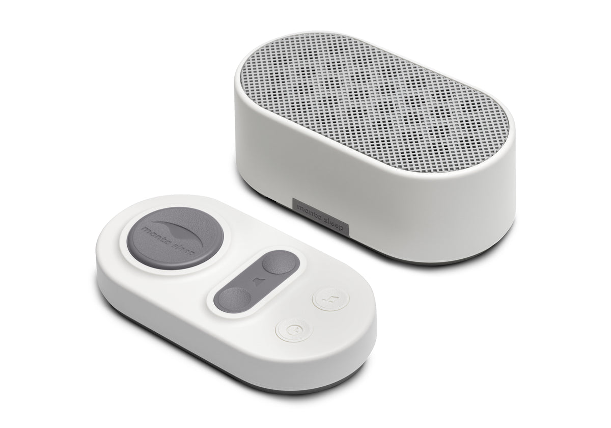 Stone White white noise machine speaker and oval wireless remote control on a white background.