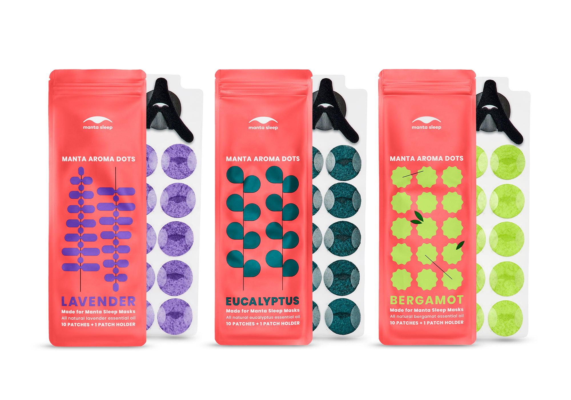 Product lineup for Lavender, Eucalyptus, and Bergamot Manta Aroma Dots, displaying each coral packet next to its respective patch sheet on white.