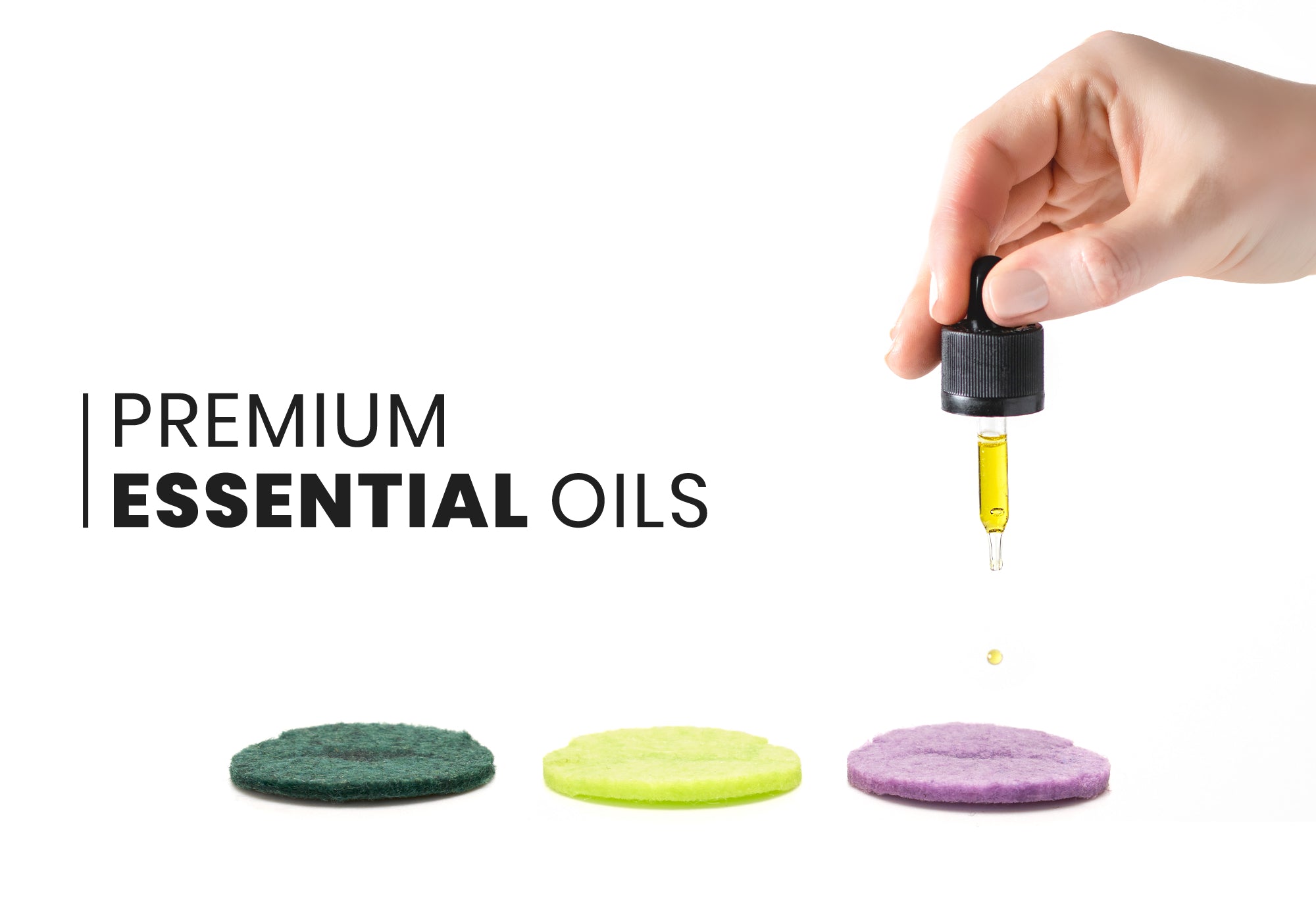 A hand holding a dropper bottle to apply a liquid drop onto three colorful felt discs, captioned "Premium essential oils".