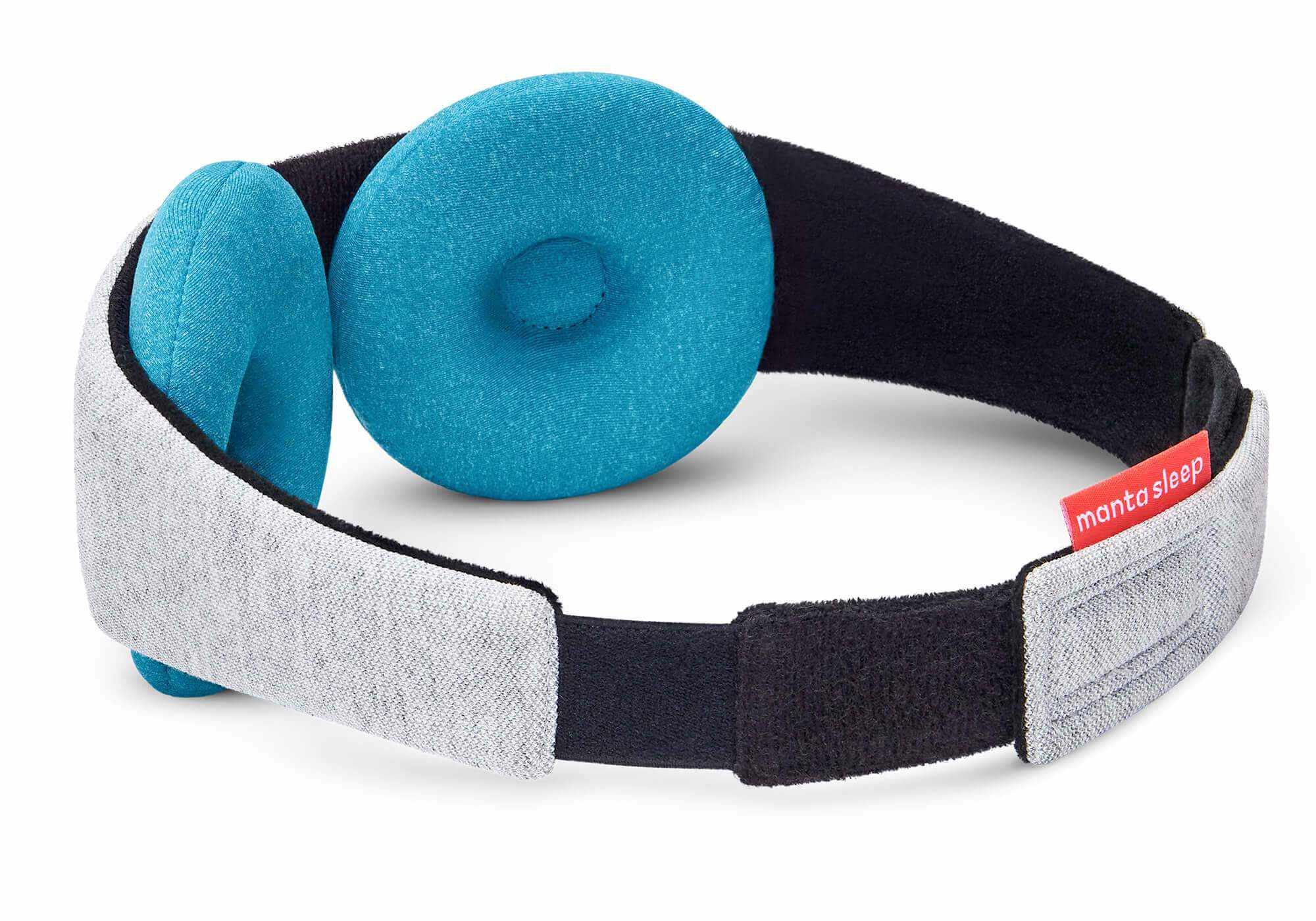 Rear three-quarter view of a grey Manta COOL Sleep Mask showing the thick blue-teal circular eye cups and the red Manta Sleep label.