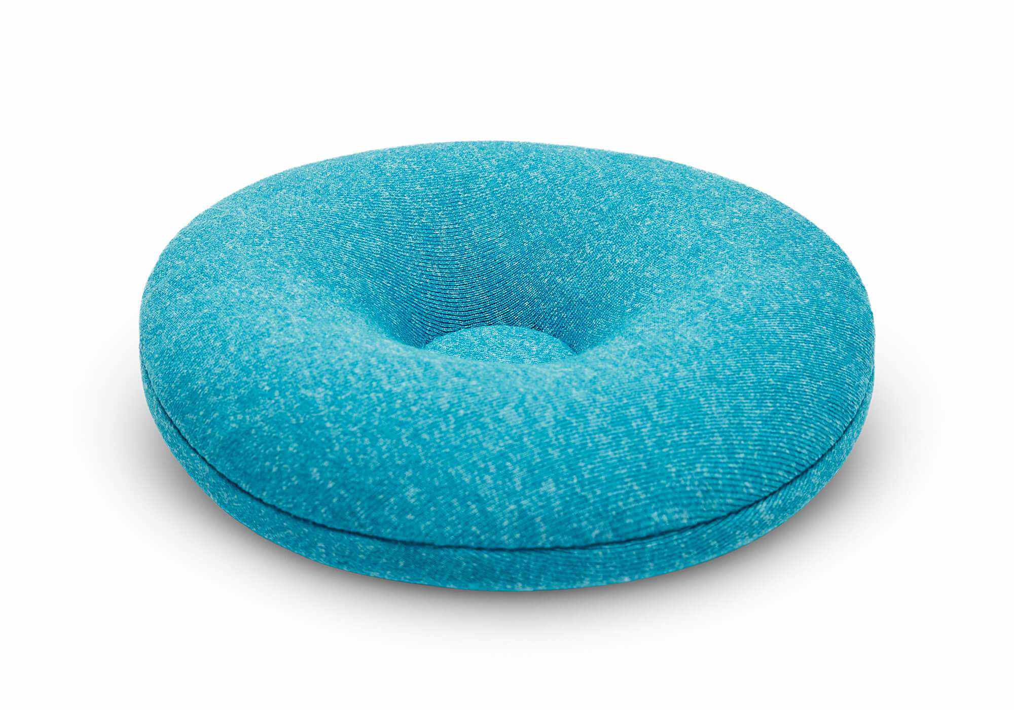 Close-up, low-angle shot of a single round blue-teal fabric eye cup with a tapered, indented center on a white background.