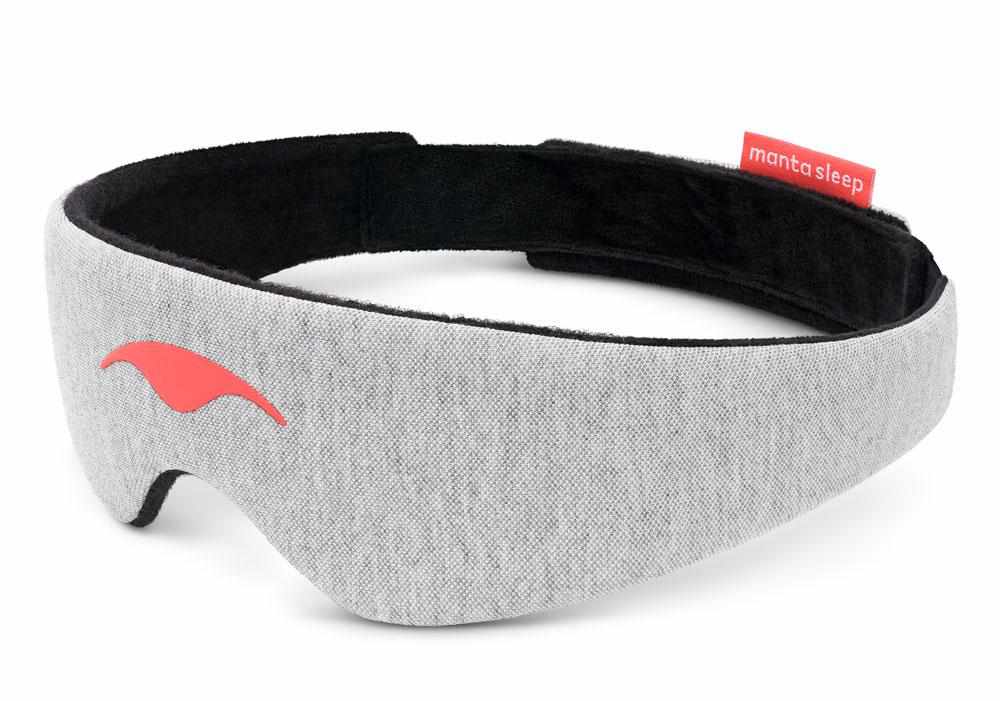 Three-quarter front view of the curved grey head strap with its coral Manta Sleep logo and soft black lining, isolated on white.
