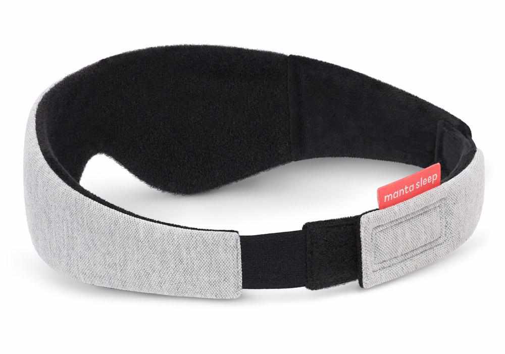 Rear view of the assembled grey head strap, showcasing the black elastic closure section and the red Manta Sleep logo tab.