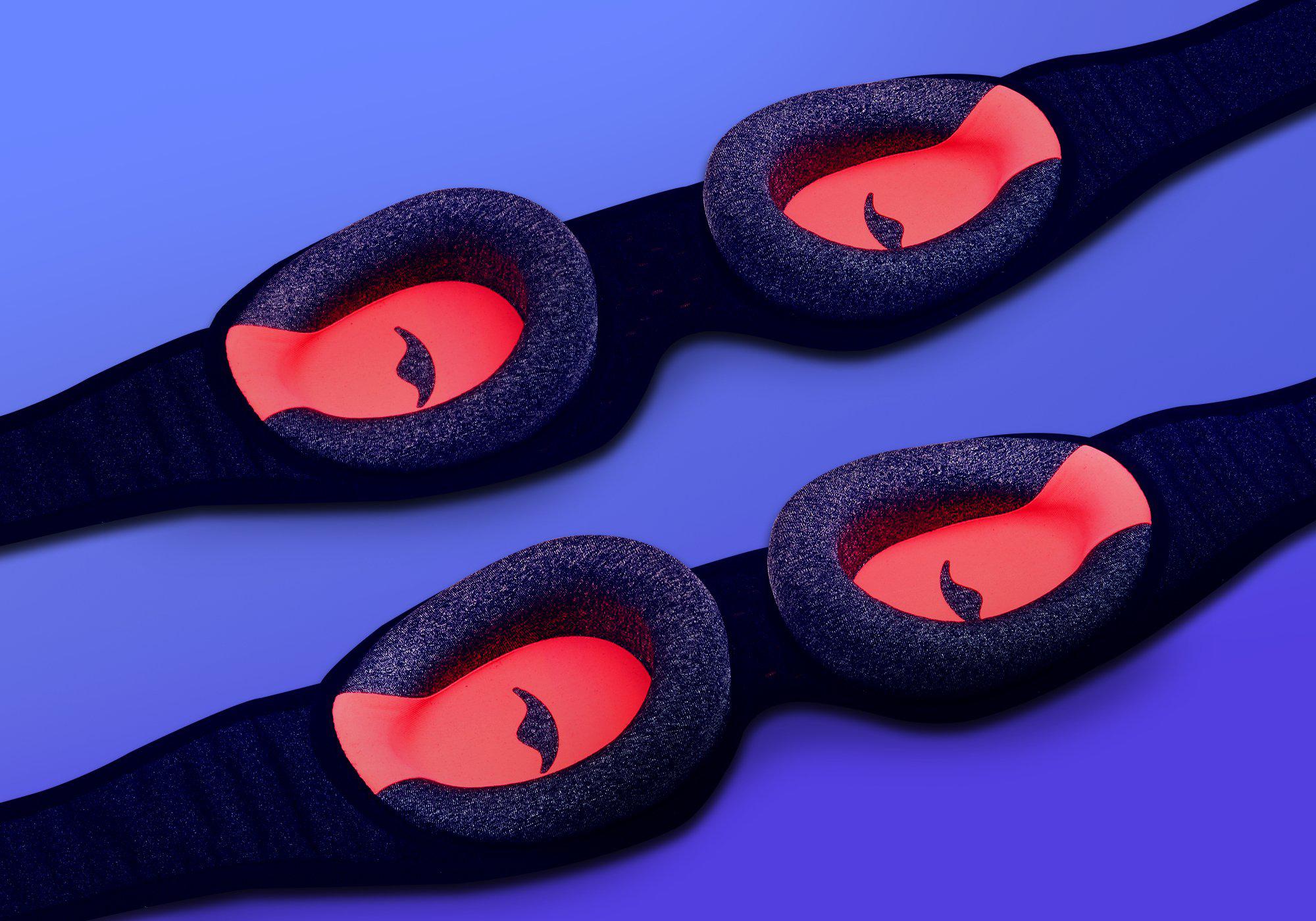 Two Manta Sleep Mask PROs arranged diagonally on a blue background, showing the inner grey foam eye cups with a red interior.