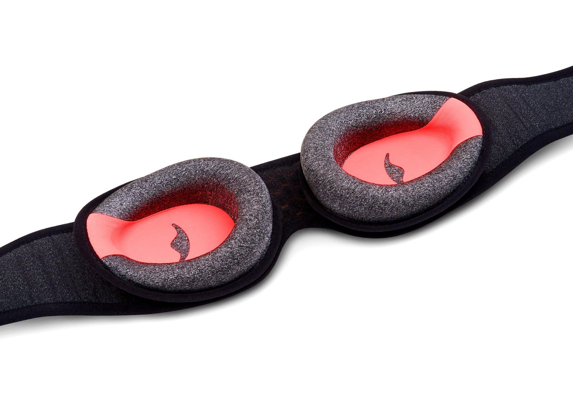 Inner view of the Manta PRO Sleep Mask showing two adjustable, grey foam C-shaped eye cups with a red interior and a central logo.