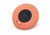 The reverse side of a circular orange eye cup, showing its black hook-and-loop fastening circle and a red Manta Sleep label.