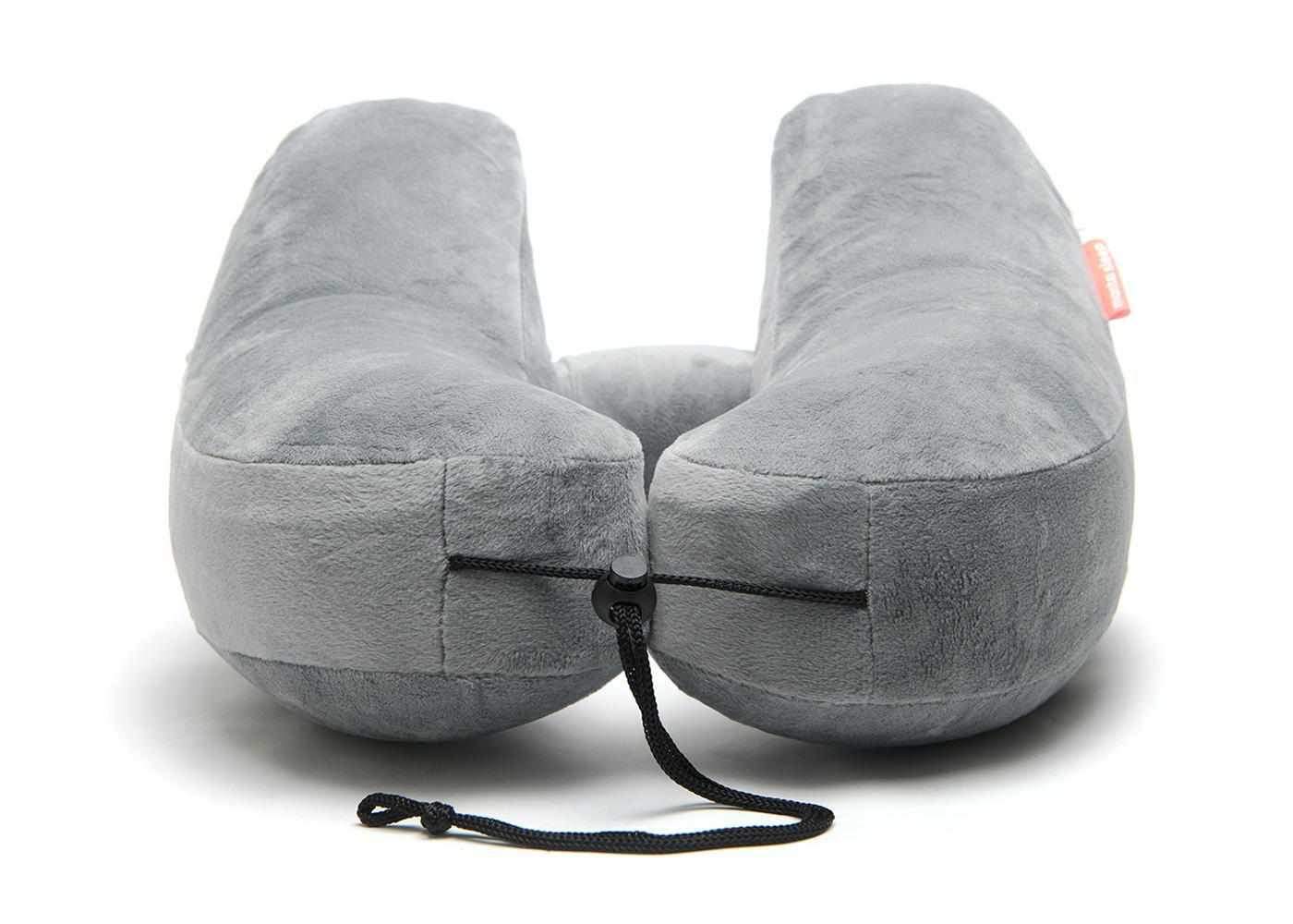 Front view of a grey plush Manta Travel Pillow showing the adjustable black drawstring cord on a white background.