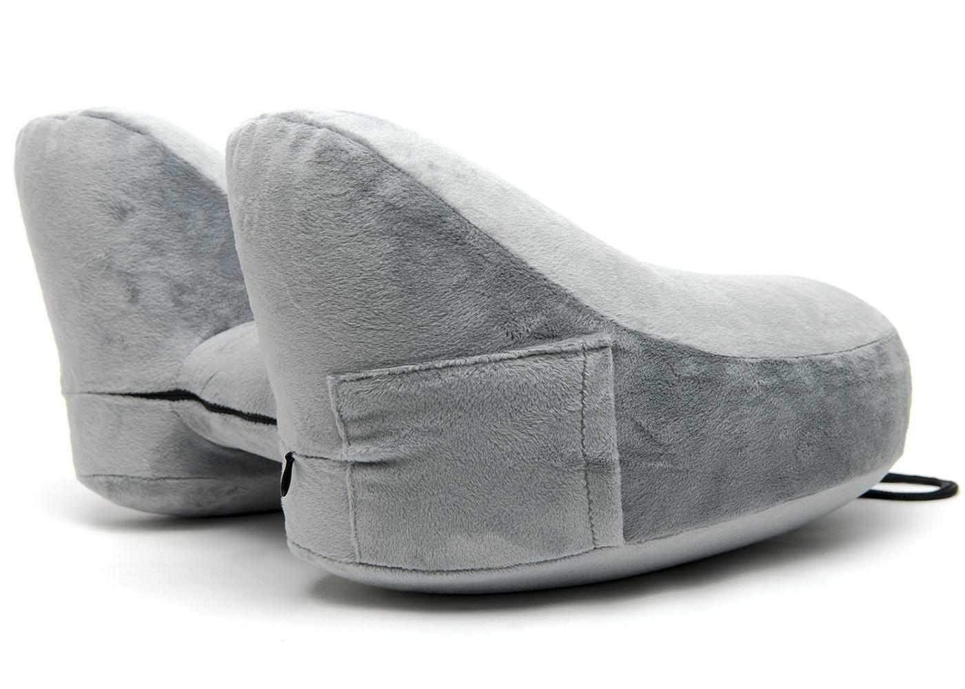 Side view of a grey plush Manta Travel Pillow, isolated on a white background.
