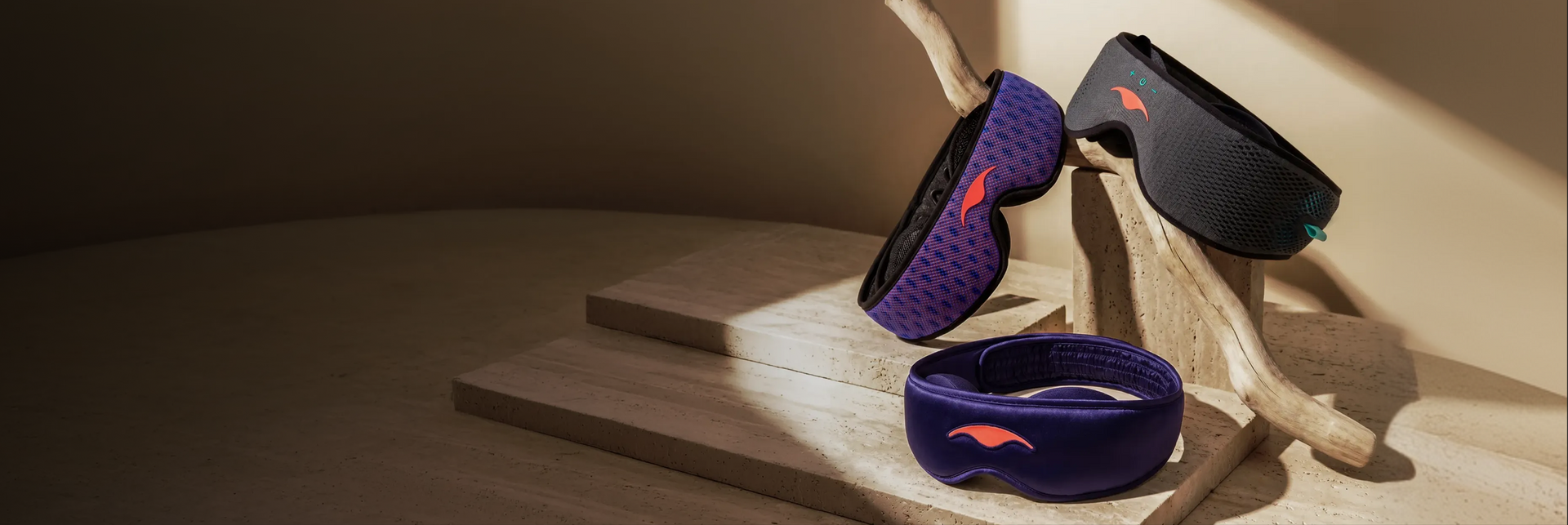 Manta PRO, SOUND and SILK Sleep Masks on a wooden-like surface.