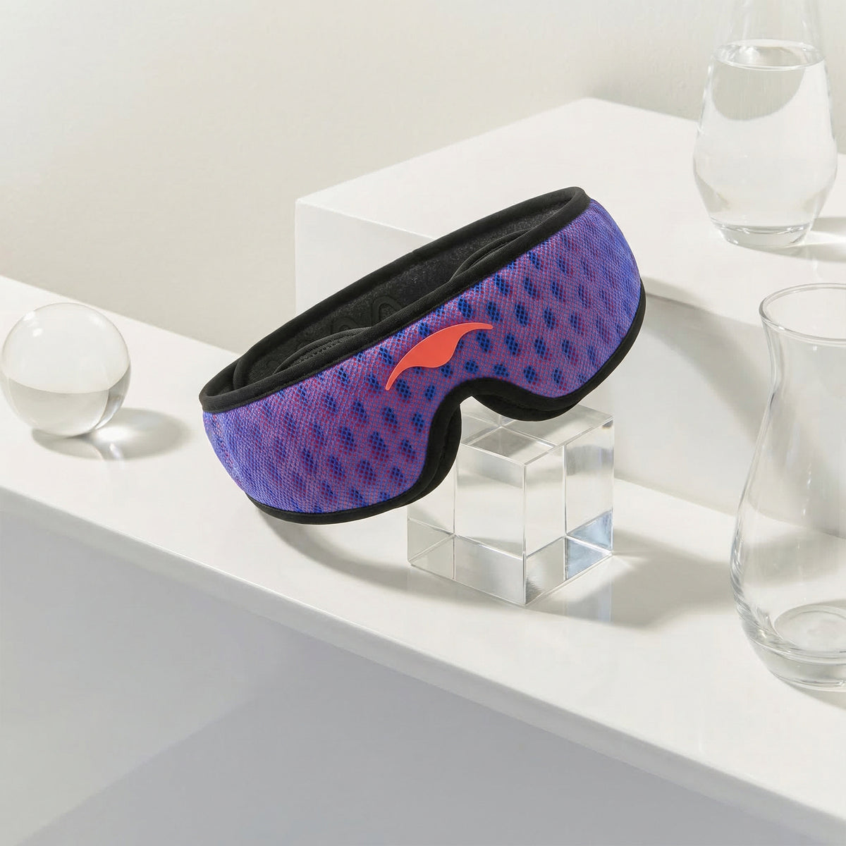 Blue and red Manta PRO Sleep Mask on a white surface.