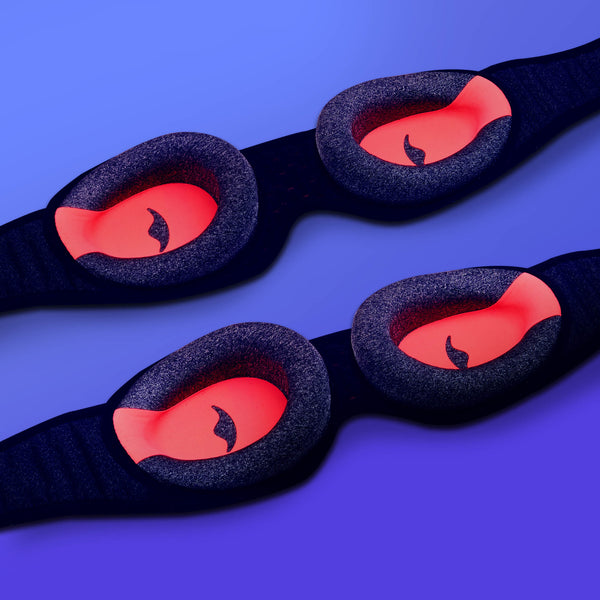 Two Manta Sleep Mask PROs arranged diagonally on a blue background, showing the inner grey foam eye cups with a red interior.