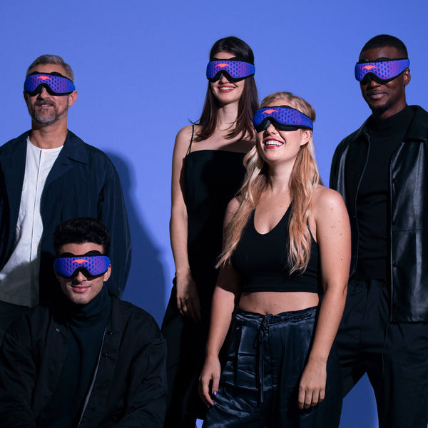 Five people wearing blue and purple Manta PRO Sleep Mask on a blue background.