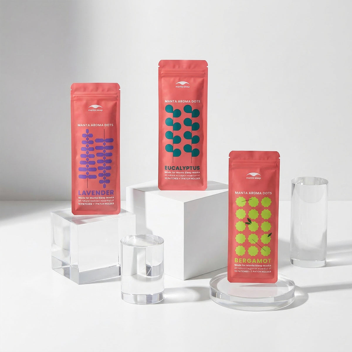 Three red Manta AROMA Dots packages labeled 'Lavender', 'Eucalyptus', and 'Bergamot' on a white background
