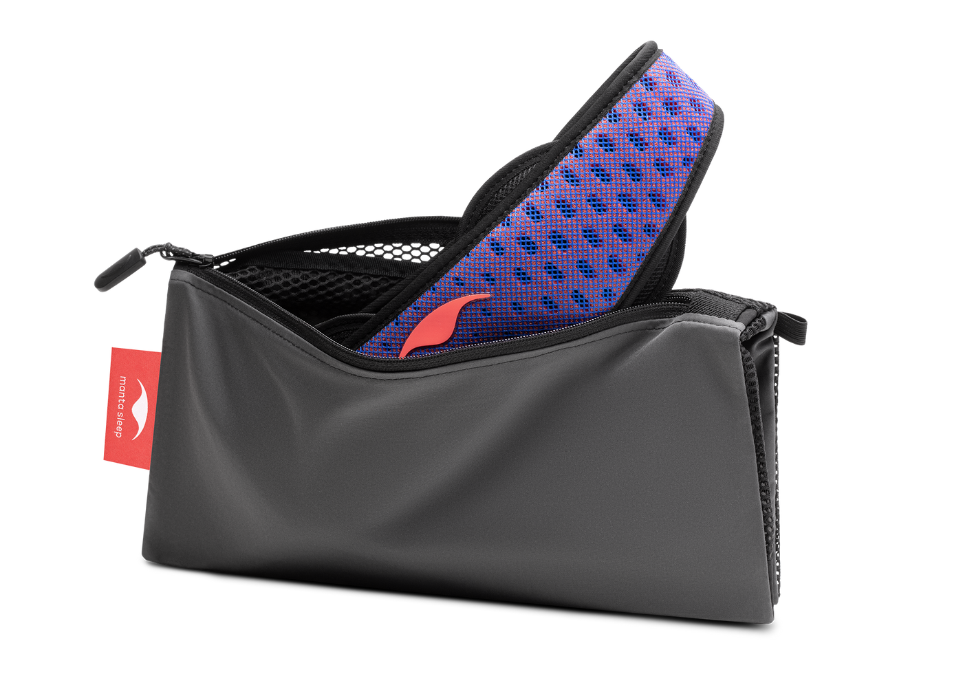 Studio shot of an open, charcoal grey zippered Manta Travel & Laundry Bag with a blue and red Manta PRO Sleep Mask peeking out, isolated on a white background.