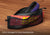 A sleep mask and Manta Aroma Dots tucked into the separate zippered black mesh storage compartment on a wooden surface. Text overlay: "Extra storage for your accessories".