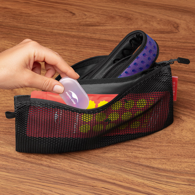 Hand reaching for Manta Sleep Earplugs case into a mesh pouch on a wooden surface.
