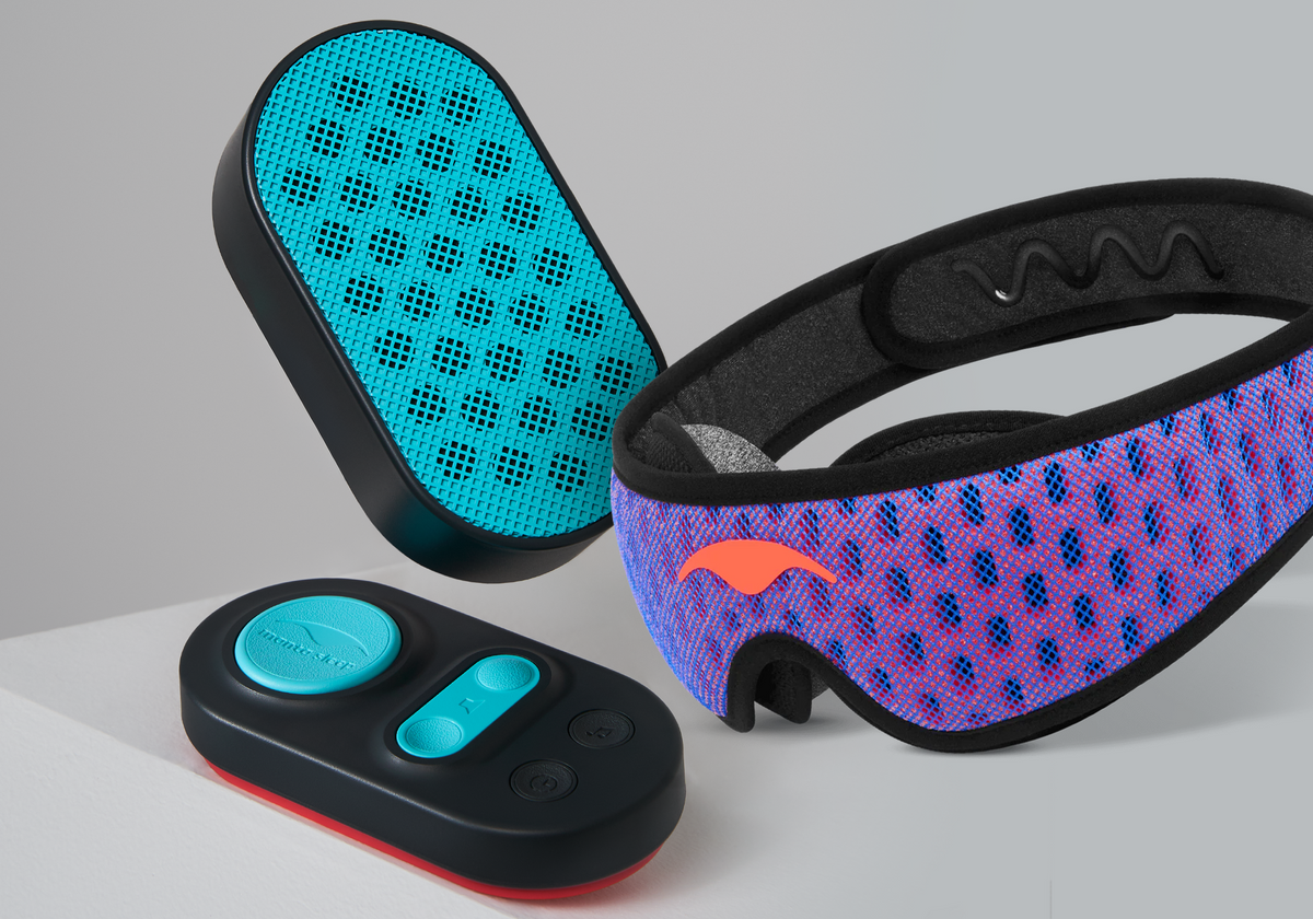 Blue and coral red Manta PRO Sleep Mask next to a black and teal Manta White Noise Machine speaker and remote pad.