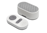 Manta White Noise Machine in Stone White paired with its matching oval wireless remote control on a white background.