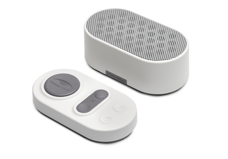 Manta White Noise Machine in Stone White paired with its matching oval wireless remote control on a white background.