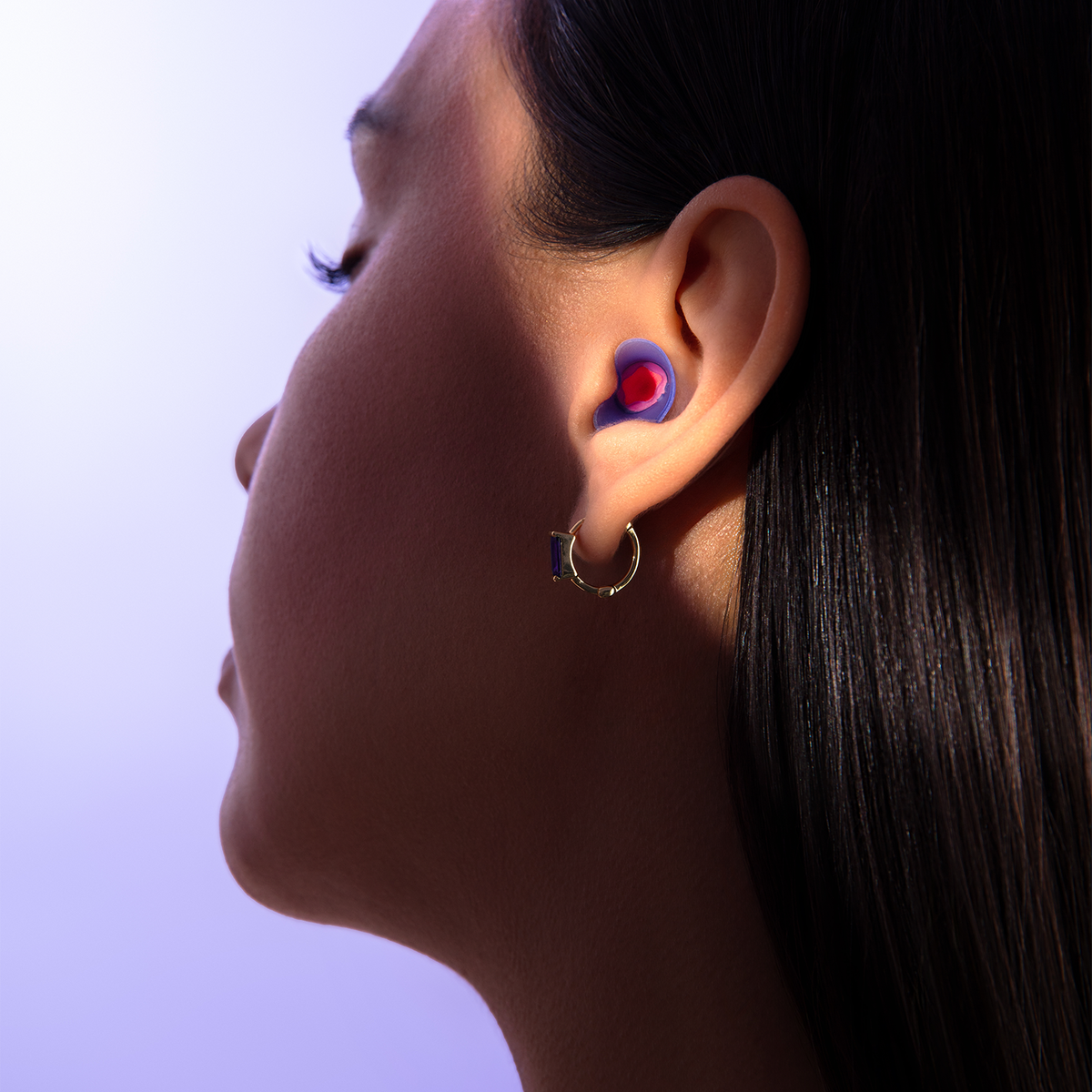 Close-up of a woman's ear with a Manta Sleep Earplug.