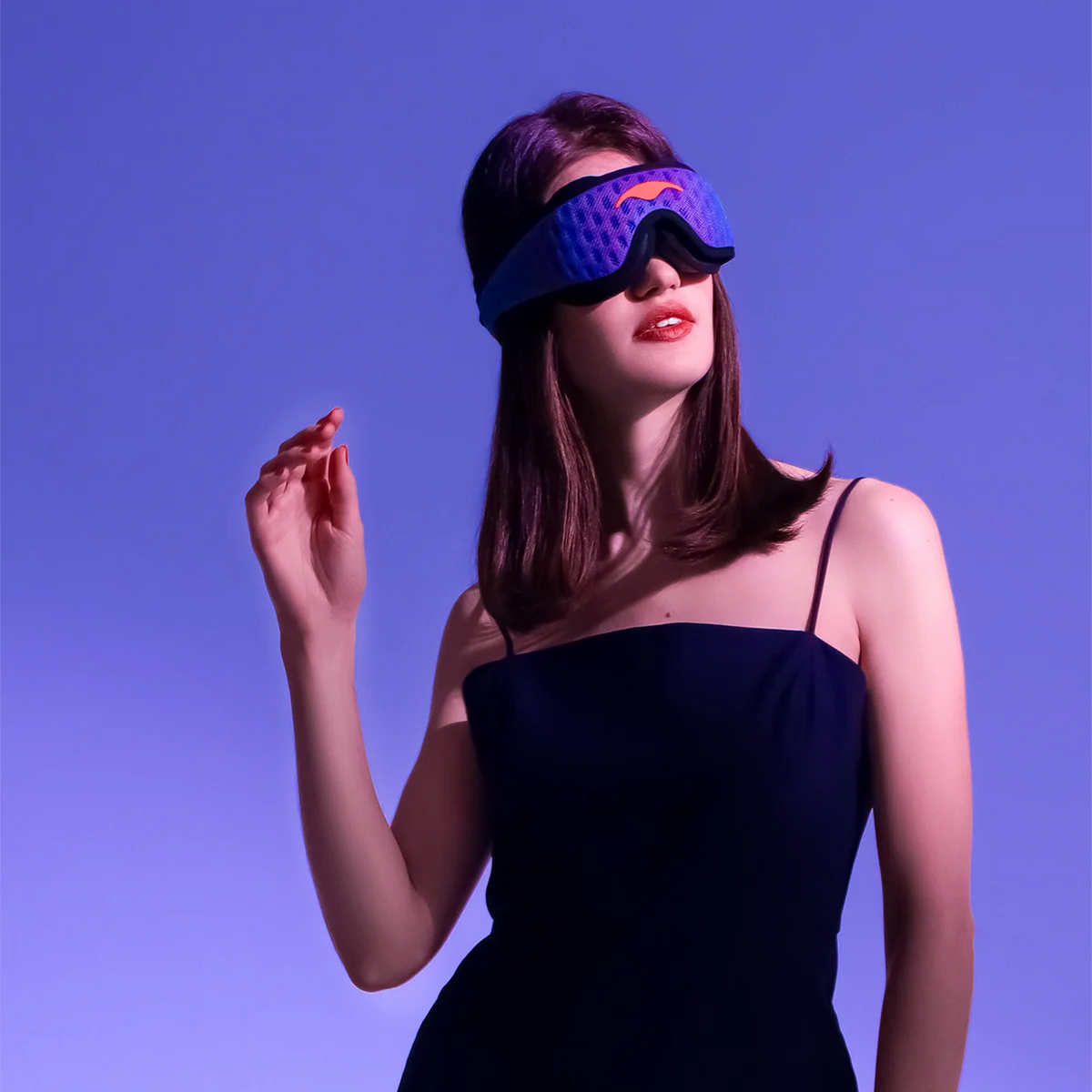 Woman wearing a purple Manta PRO Sleep Mask against a purple background