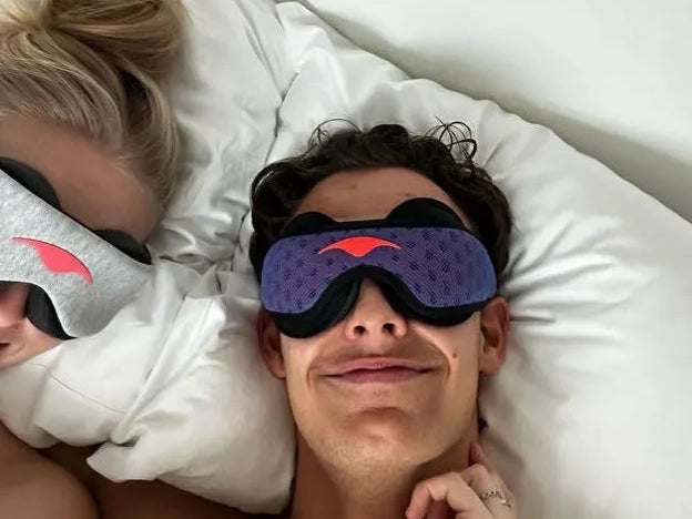Two people lying in bed wearing classic Manta Sleep Mask and Manta PRO Sleep Mask.