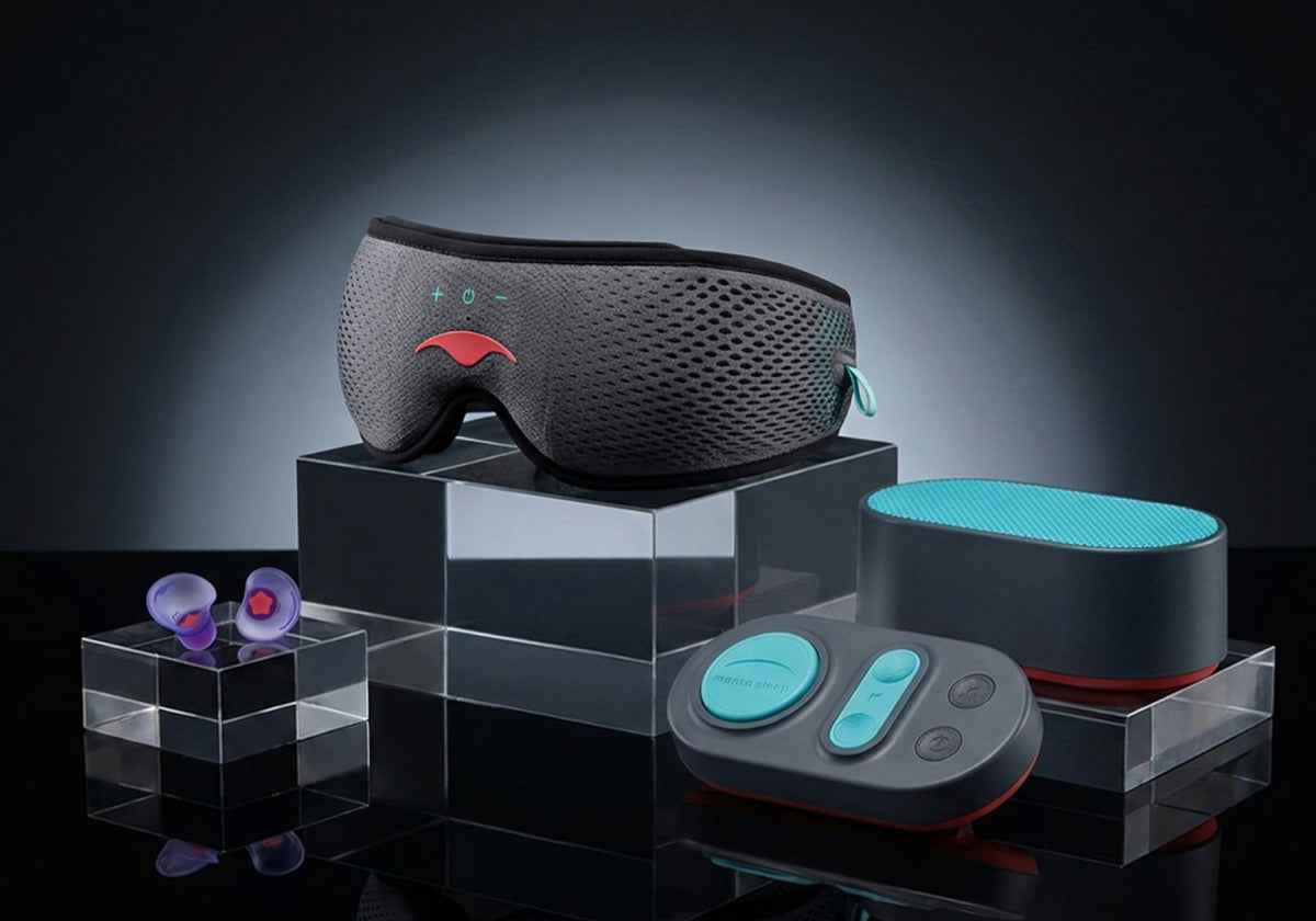 Manta SOUND mask, earplugs, black and teal white noise machine, and remote on glass stands against a dark background.