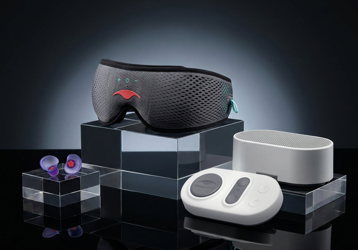 Manta SOUND mask, purple earplugs, Stone White white noise machine, and remote on glass stands.